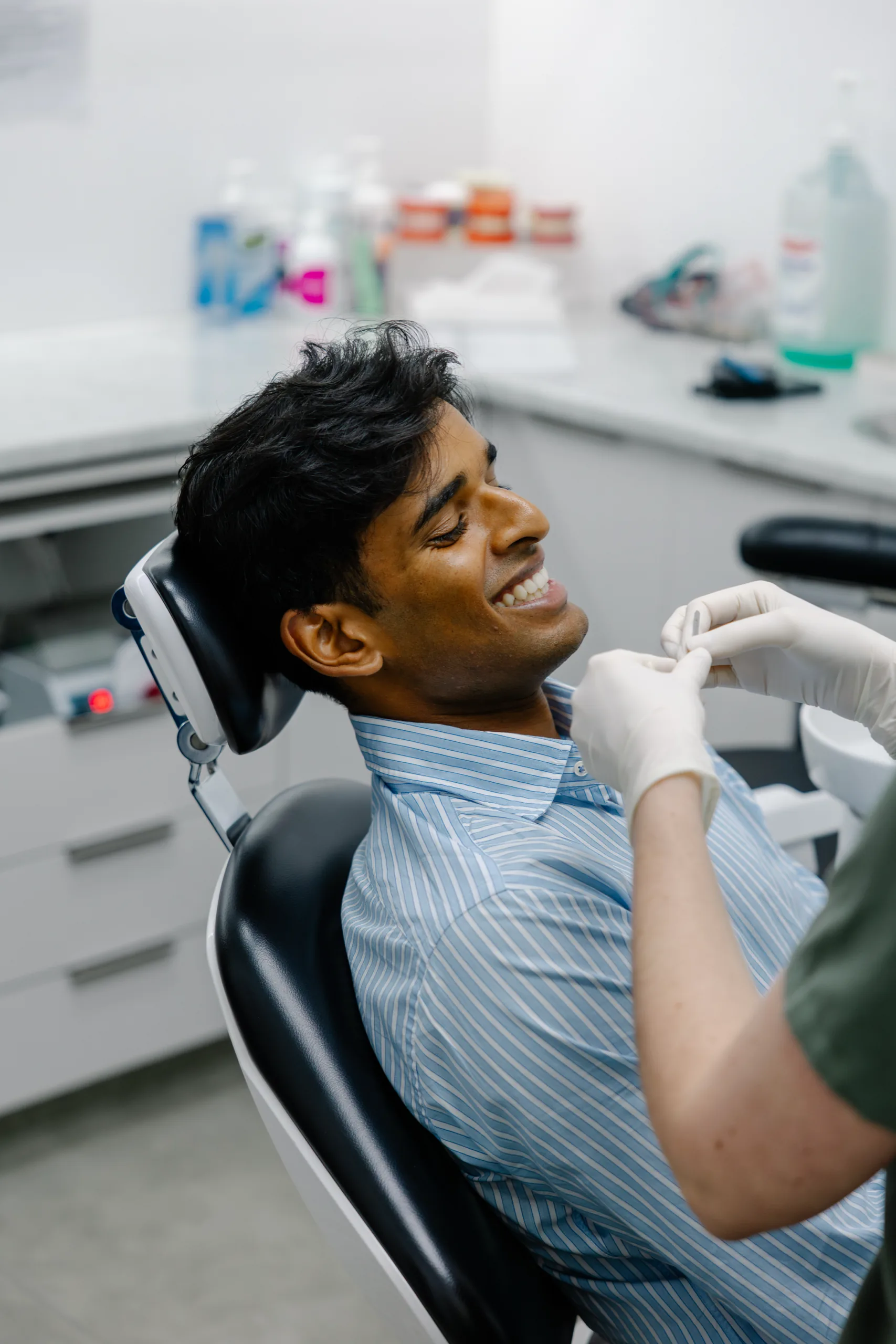 A patient smiling during a consultation at Dental Spot