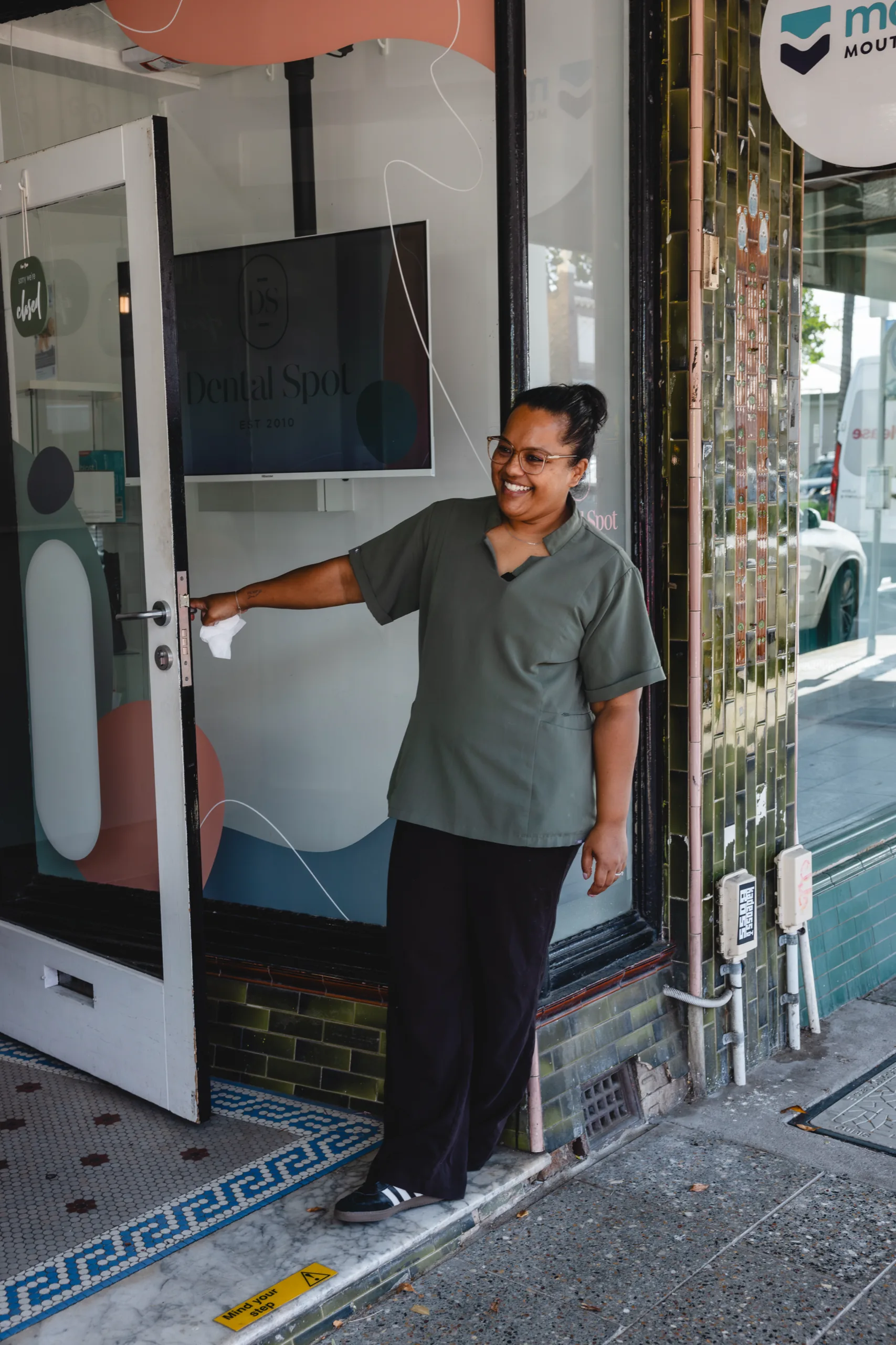 A Dental Spot team member welcoming a visitor at the clinic door