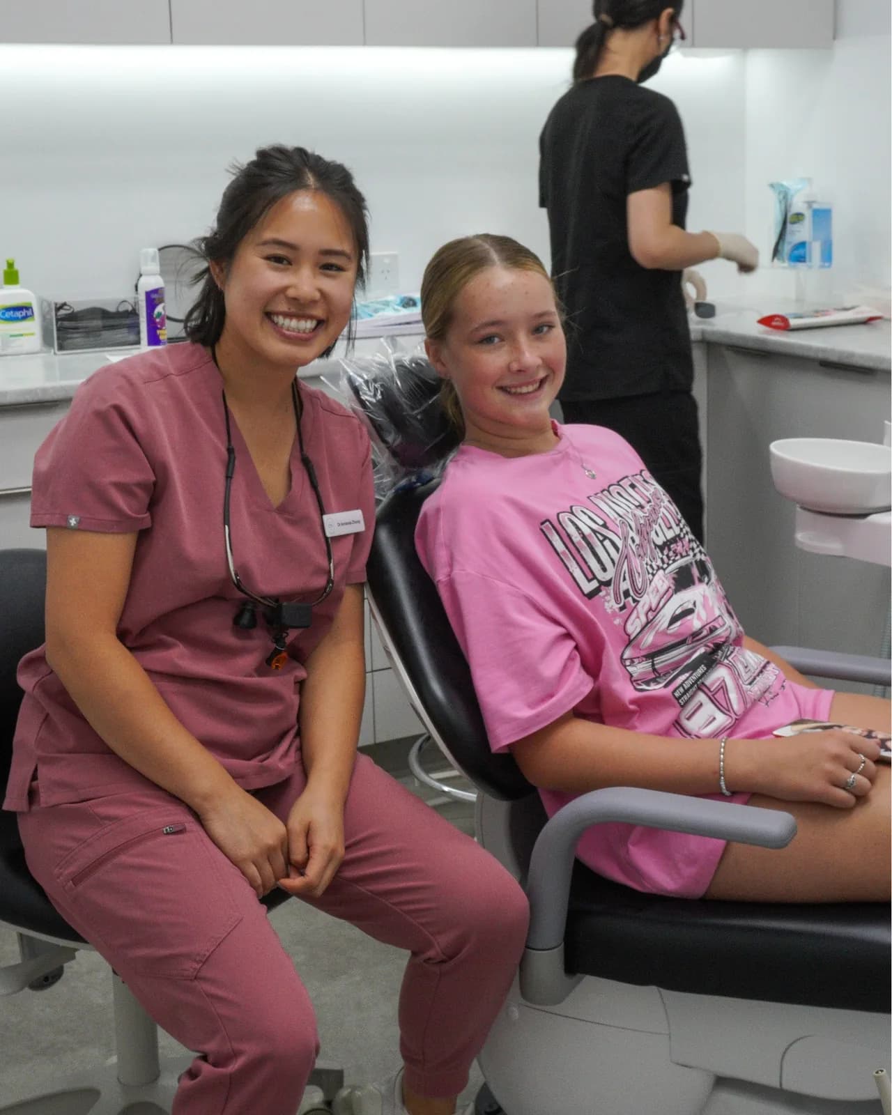 Dr Amanda Zhong with a smiling young patient in the chair